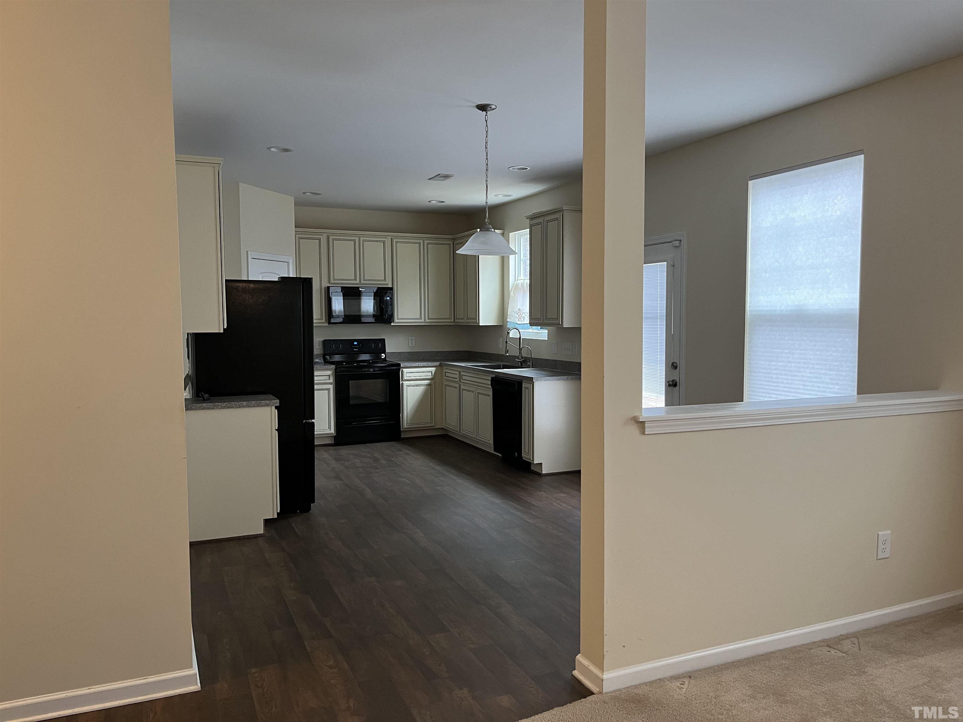2499 Longshadow Drive Graham, NC 27253 - Photo 14 of 14 a view of kitchen with refrigerator stove and wooden floor
