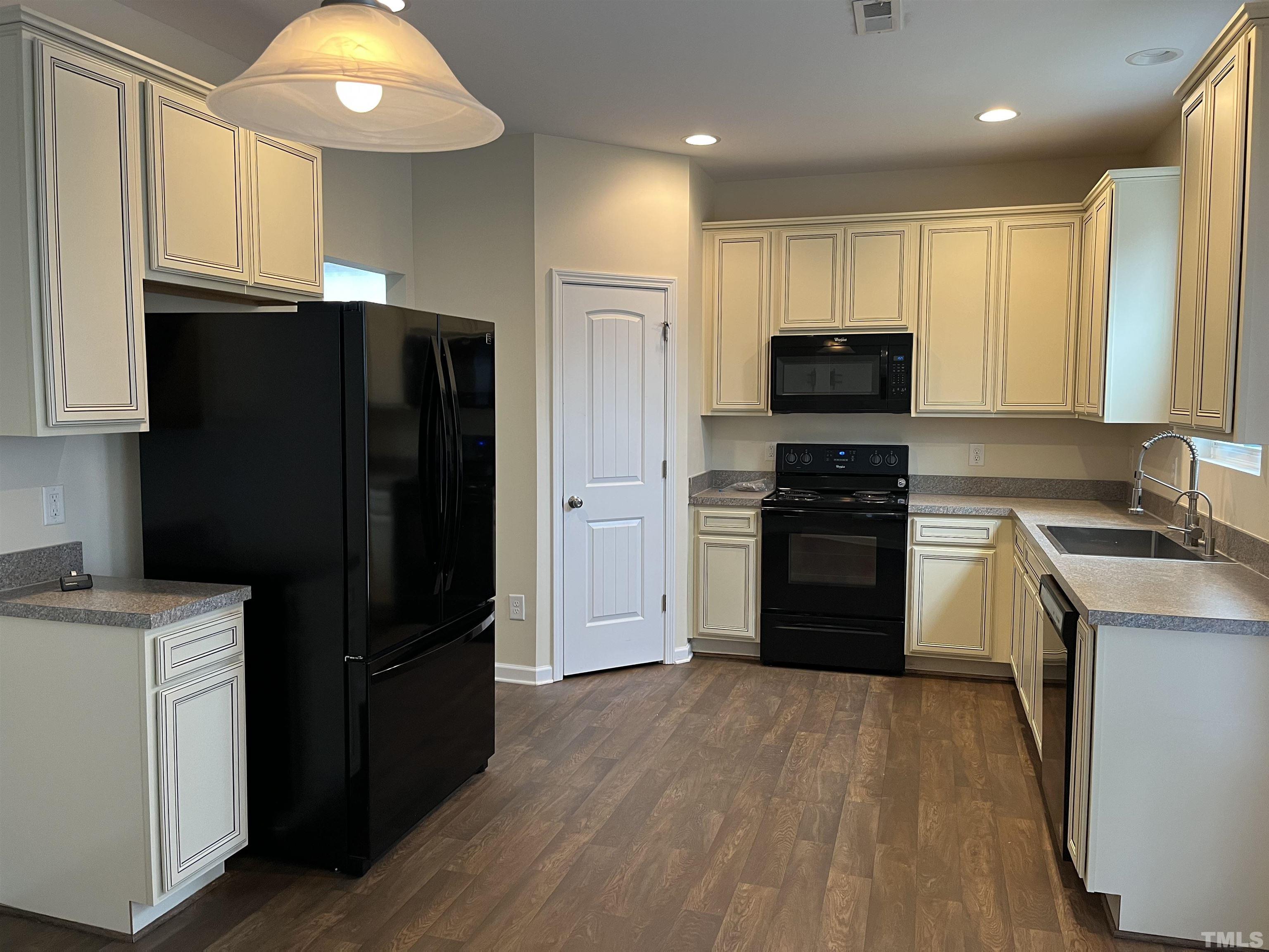 2499 Longshadow Drive Graham, NC 27253 - Photo 4 of 14 a kitchen with a refrigerator and a stove top oven