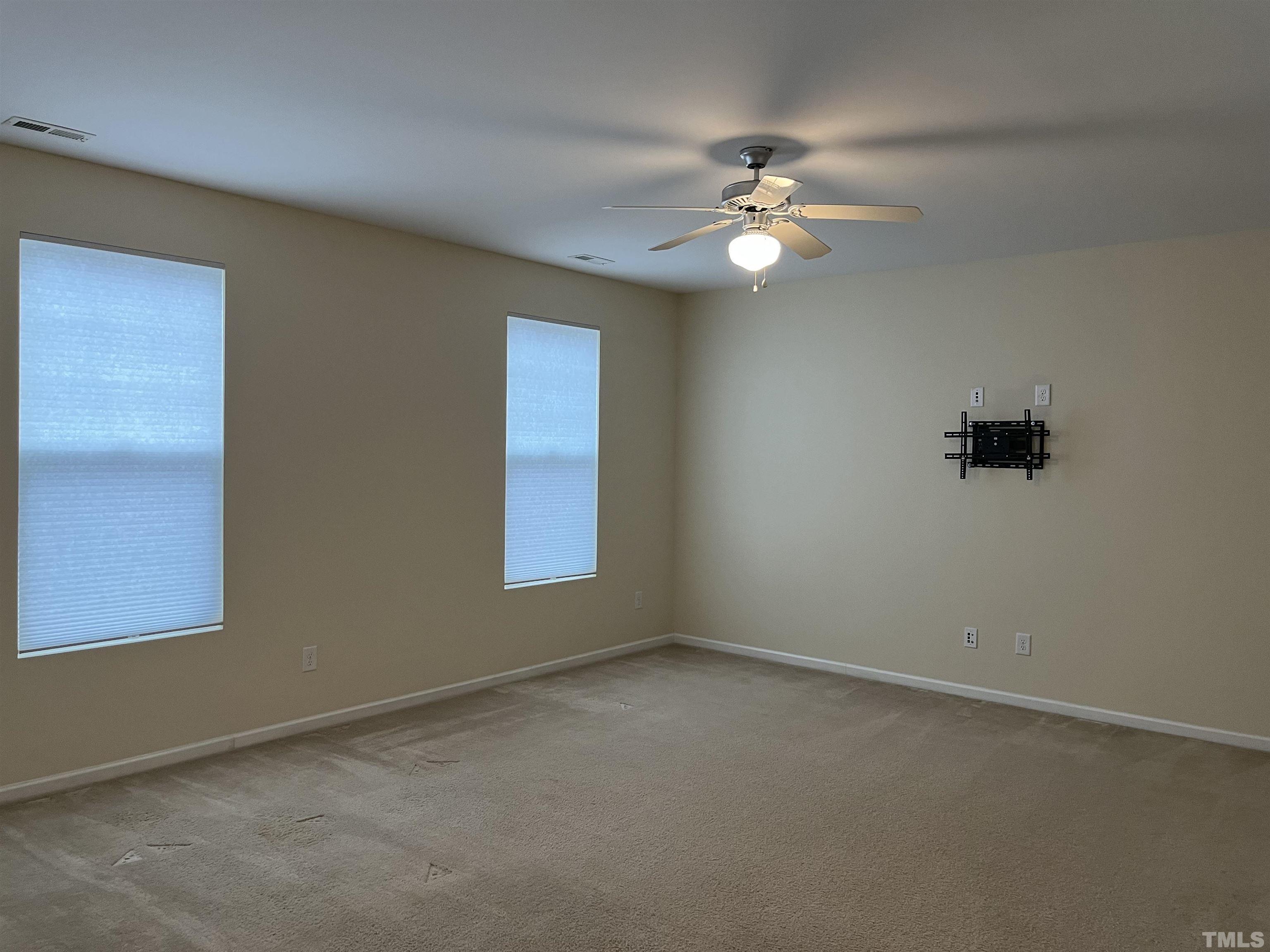 2499 Longshadow Drive Graham, NC 27253 - Photo 5 of 14 an empty room with windows and fan