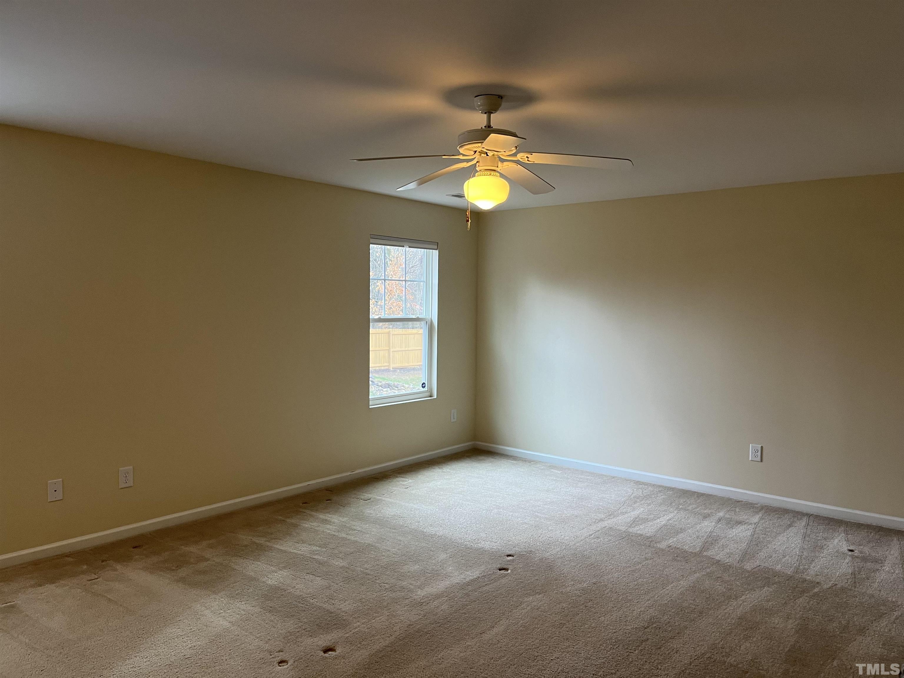 2499 Longshadow Drive Graham, NC 27253 - Photo 7 of 14 an empty room with a window and chandelier