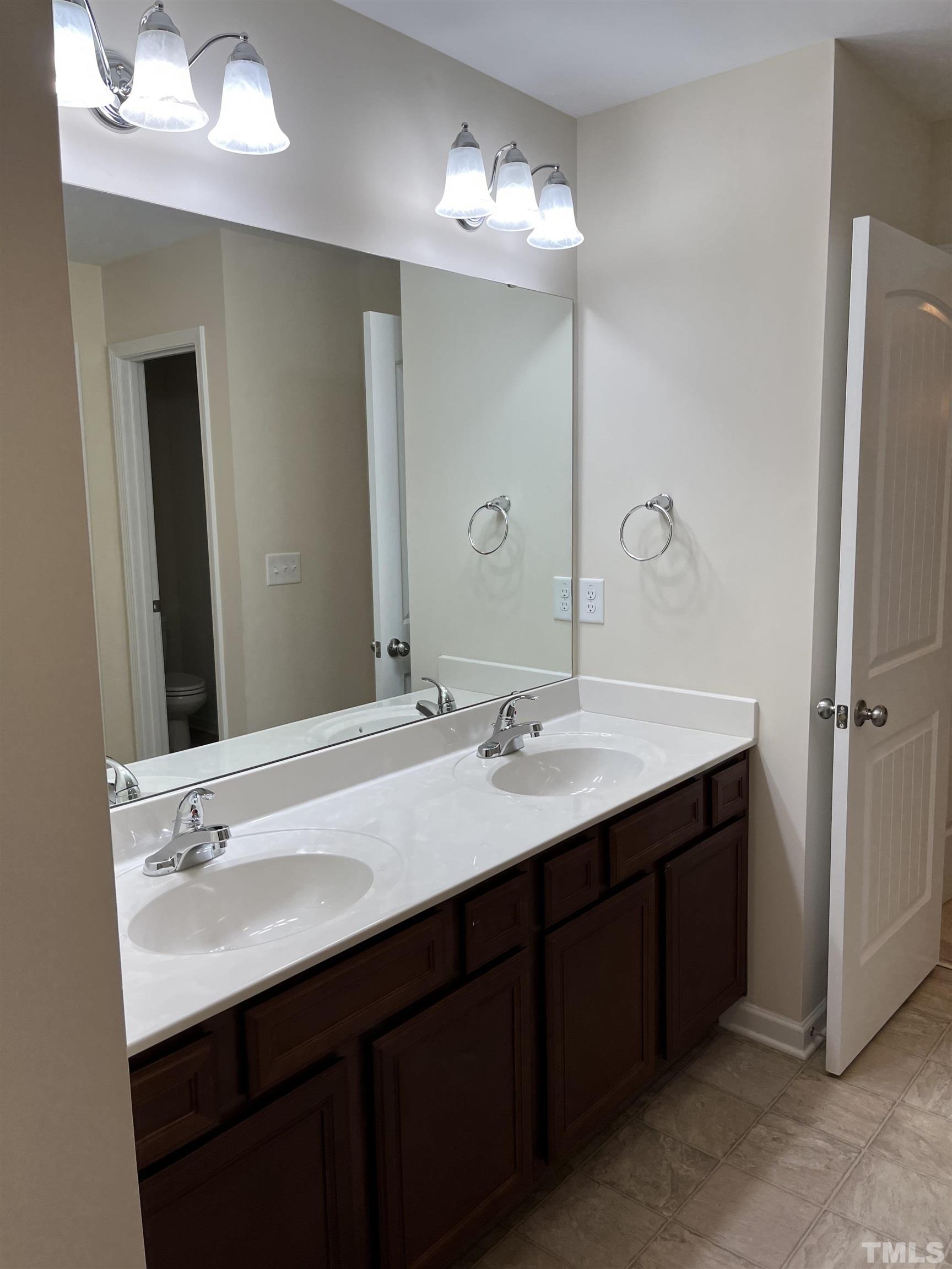 2499 Longshadow Drive Graham, NC 27253 - Photo 8 of 14 a bathroom with a sink double vanity and a mirror