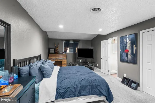 a bed room with a bed and a large window