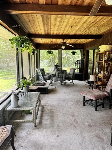 a backyard of a house with lots of green space and outdoor seating