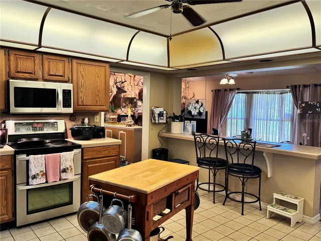 a bathroom with a granite countertop sink a mirror and shower