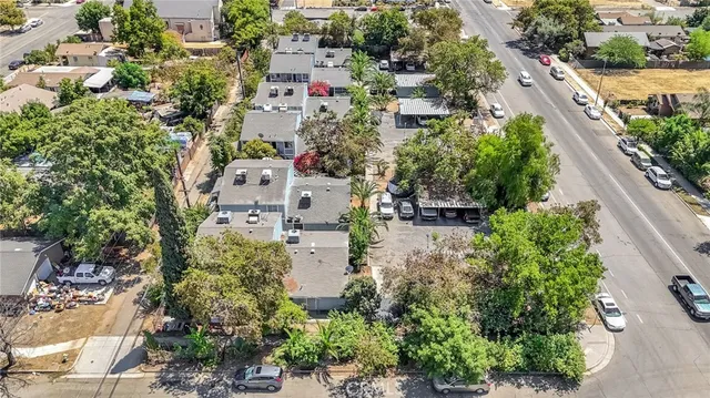 an aerial view of residential house with outdoor space and trees all around