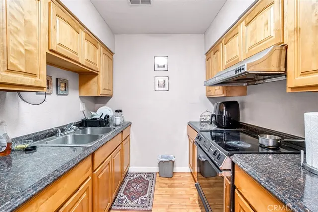 a kitchen that has a sink and a stove