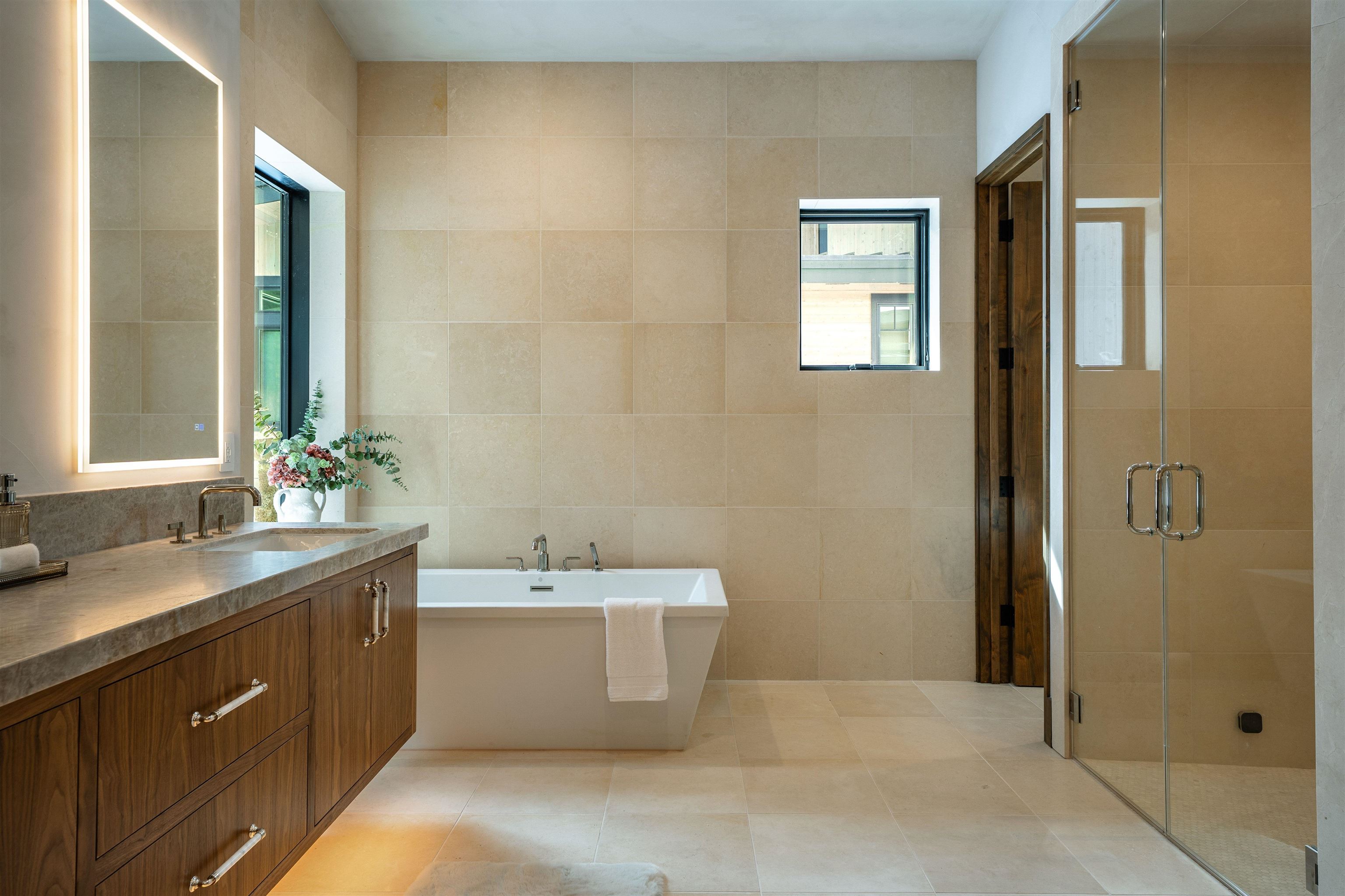 11646 Henness Road Truckee, CA 96161 - Photo 19 of 28 a bathroom with a double vanity sink a mirror and a shower