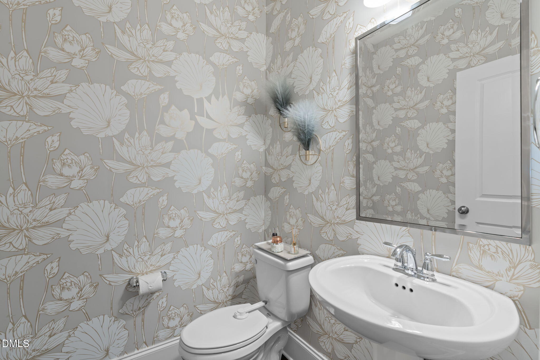 4144 Olde Judd Drive Willow Spring, NC 27592 - Photo 22 of 52 a bathroom with a sink a toilet and a mirror