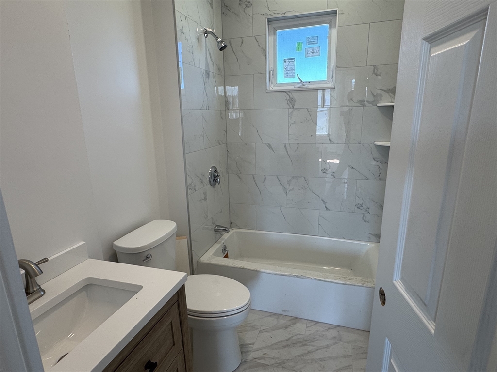 8 Carnes Street, Unit 2R Lynn, MA 01905 - Photo 12 of 15 a bathroom with a sink a toilet and bathtub