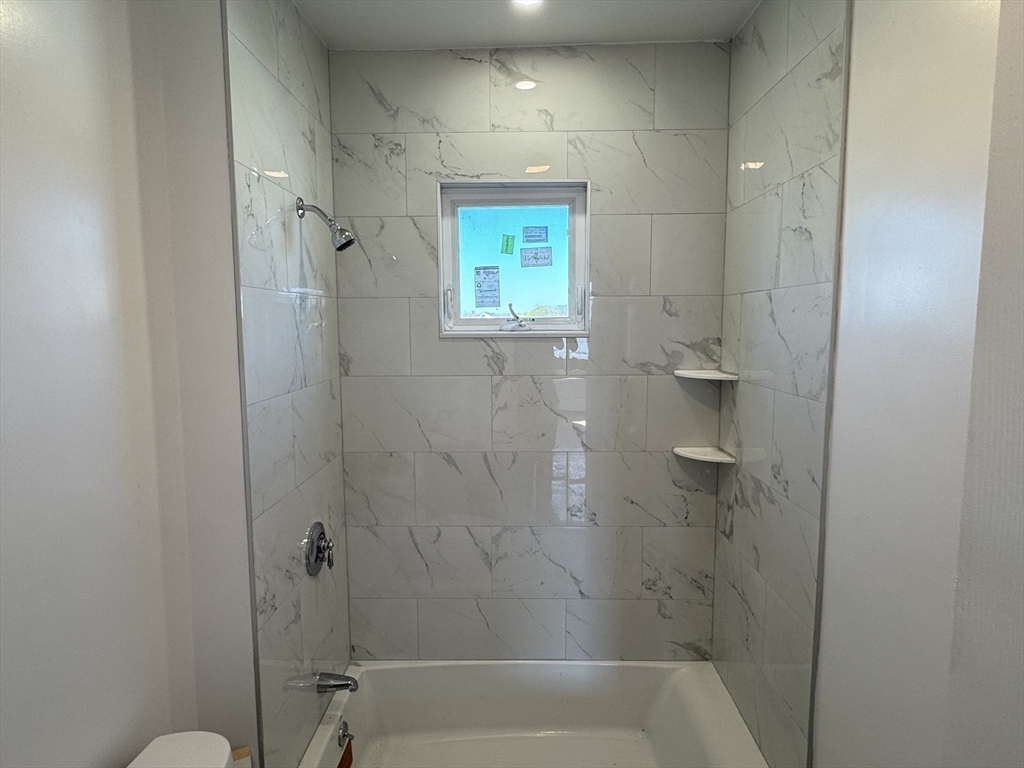 8 Carnes Street, Unit 2R Lynn, MA 01905 - Photo 14 of 15 a bathroom with a window and a shower