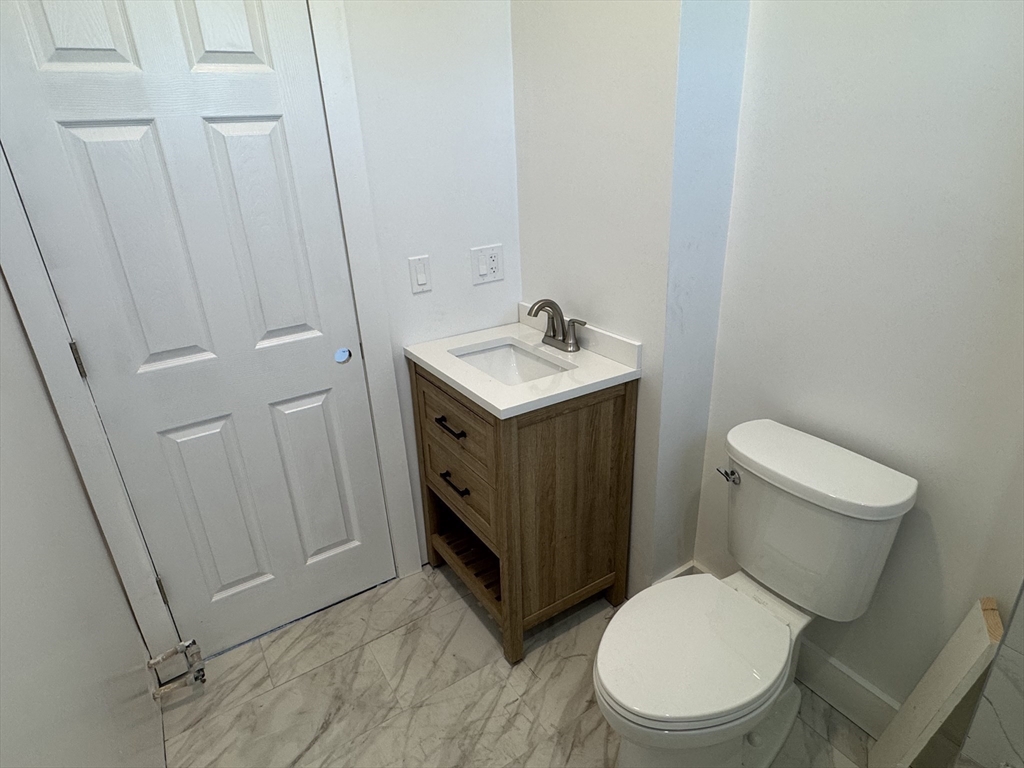 8 Carnes Street, Unit 2R Lynn, MA 01905 - Photo 15 of 15 a white toilet sitting next to a sink