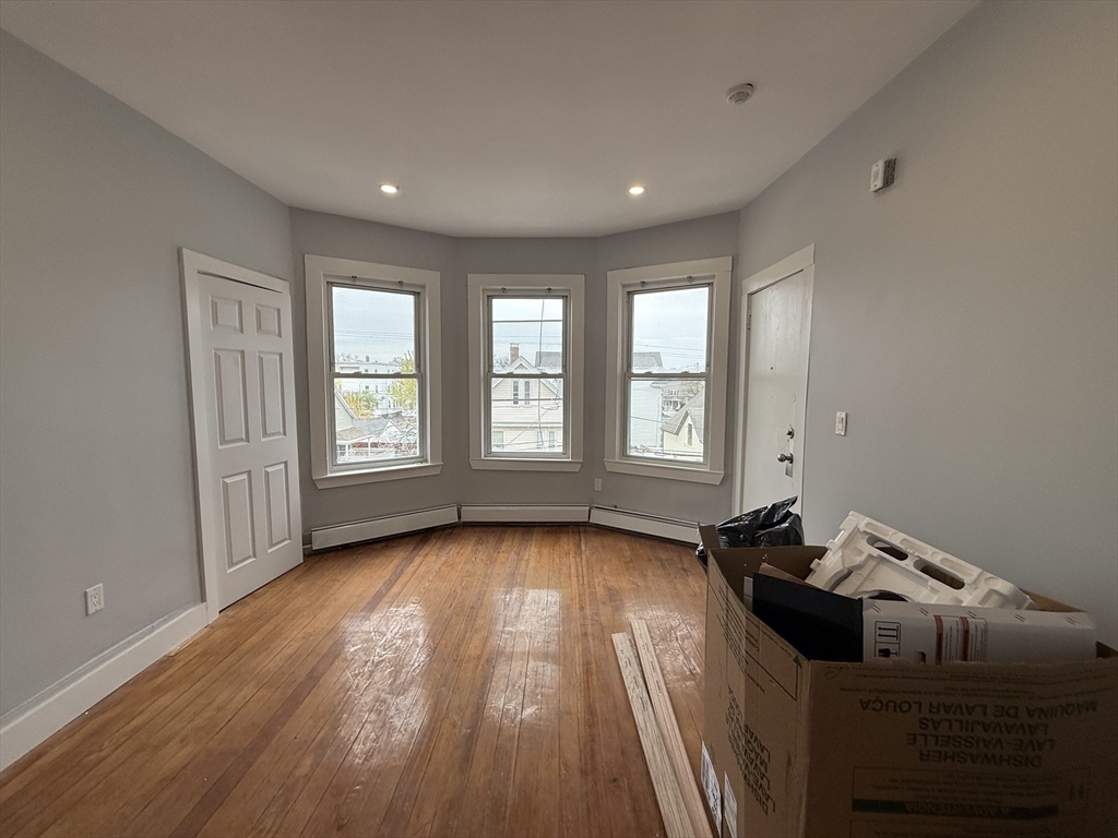 8 Carnes Street, Unit 2R Lynn, MA 01905 - Photo 4 of 15 a view of a room with wooden floor and windows