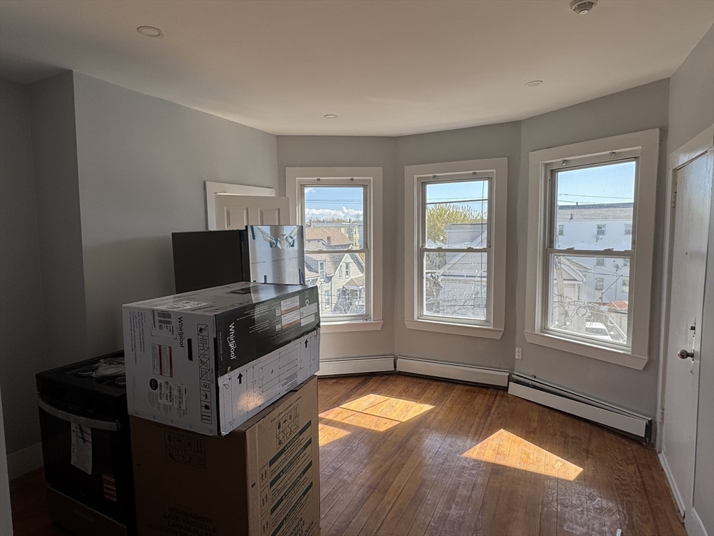 8 Carnes Street, Unit 2R Lynn, MA 01905 - Photo 5 of 15 a living room with furniture and a flat screen tv