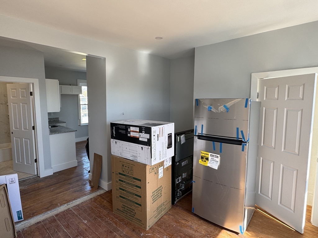 8 Carnes Street, Unit 2R Lynn, MA 01905 - Photo 7 of 15 a view of kitchen with refrigerator stove and wooden floor
