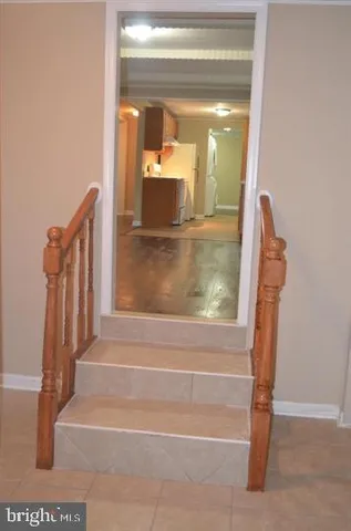 a view of an empty room with wooden floor and closet