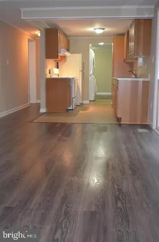 a view of a room with wooden floor and window