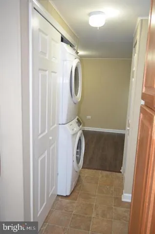 a dining room with furniture and a potted plant