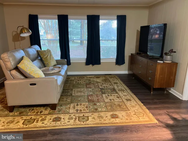 a front view of a house with a yard and trees