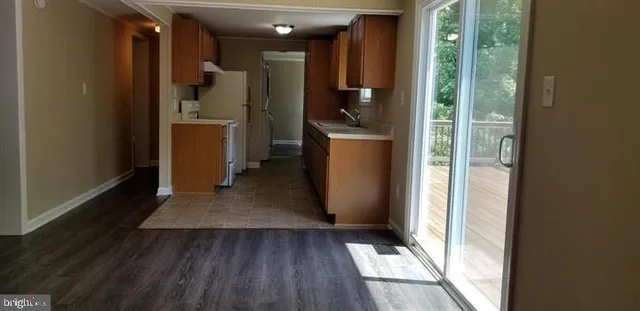 a view of a refrigerator in kitchen and wooden floor