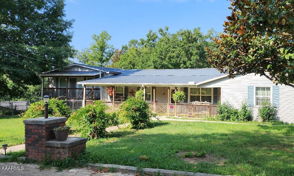 3491 Pleasant Grove Road Winfield, TN 37892 - Photo 1 of 40 a front view of a house with a yard