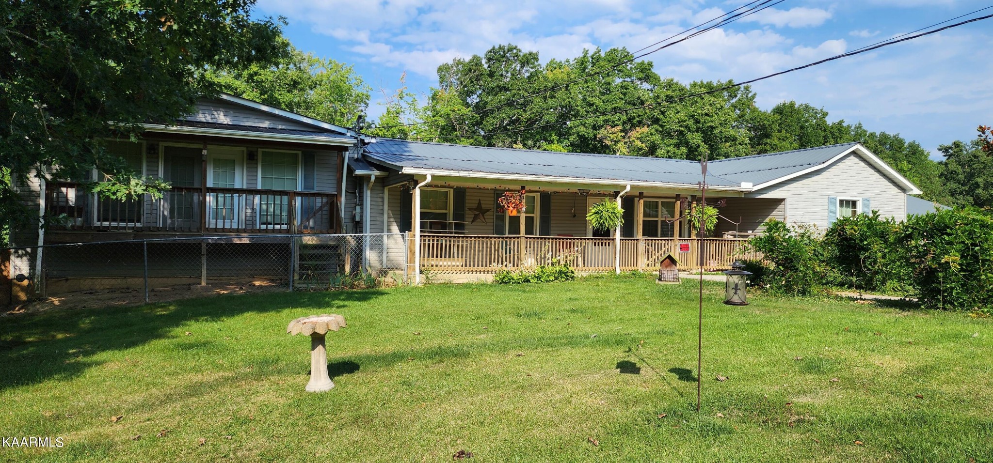 3491 Pleasant Grove Road Winfield, TN 37892 - Photo 2 of 40 a backyard of a house with table and chairs