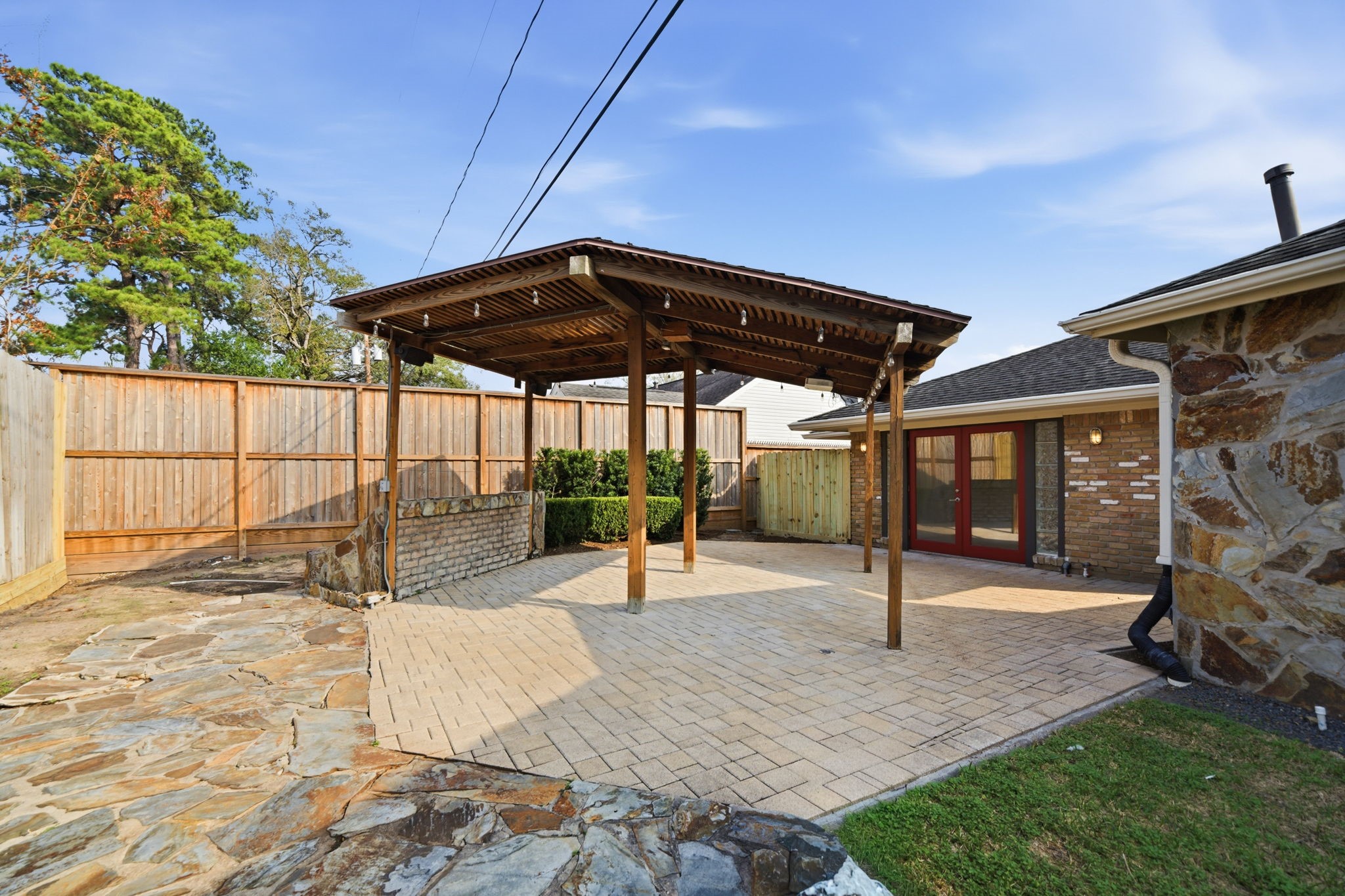 531 Azaleadell Drive Houston, TX 77018 - Photo 32 of 37 The backyard opens to a spacious paved patio anchored by a custom wood pergola, creating a natural focal point for outdoor dining or weekend entertaining. The thoughtful layout allows for multiple seating and activity zones.