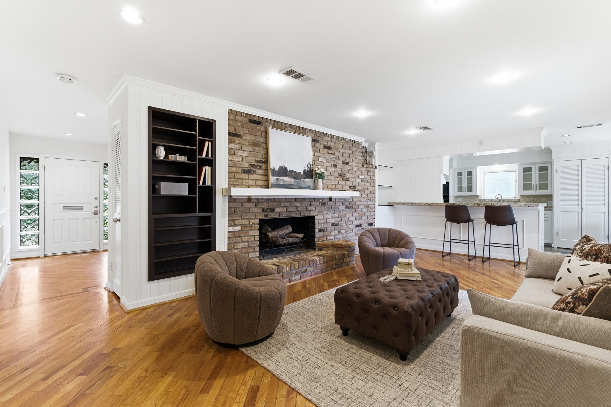 531 Azaleadell Drive Houston, TX 77018 - Photo 9 of 37 From this angle, the seamless connection between living and kitchen is fully appreciated. Clean white paneled walls and updated finishes give the space a crisp, cohesive look that feels both classic and refreshed.