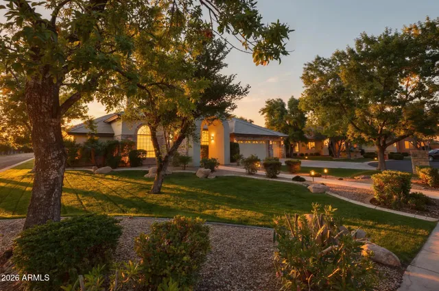 a view of a house with backyard and trees