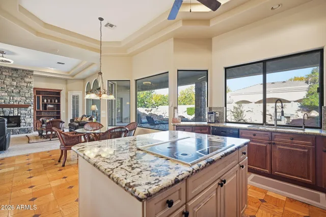 a living room with kitchen island granite countertop furniture and a large window