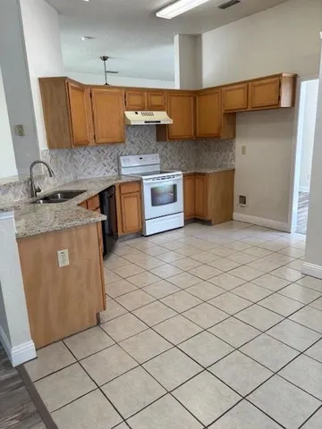 a kitchen with stainless steel appliances granite countertop a sink and cabinets