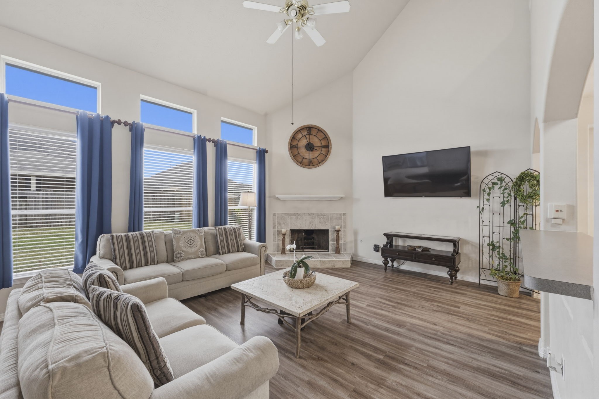 3006 Country Boy Court Spring, TX 77373 - Photo 3 of 17 a living room with furniture a fireplace a flat screen tv and a large window