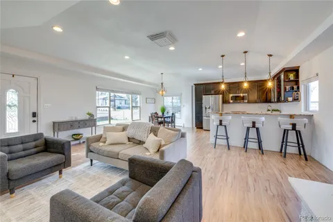 a living room with furniture and kitchen view