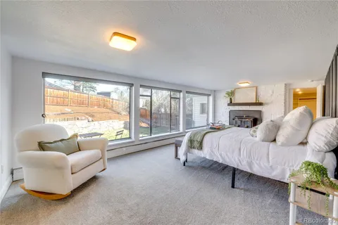 a bedroom with furniture and a large window