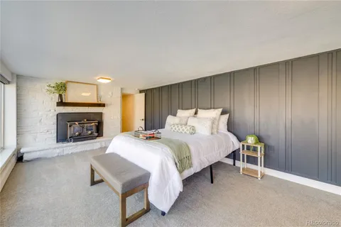 a spacious bedroom with a bed and a fireplace