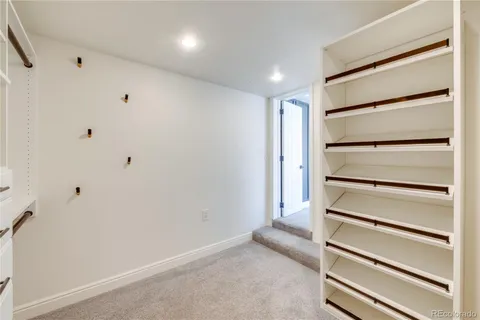 a view of walk in closet with empty racks