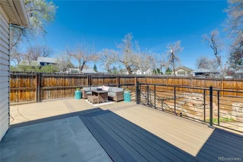 a view of a balcony with wooden floor and fence