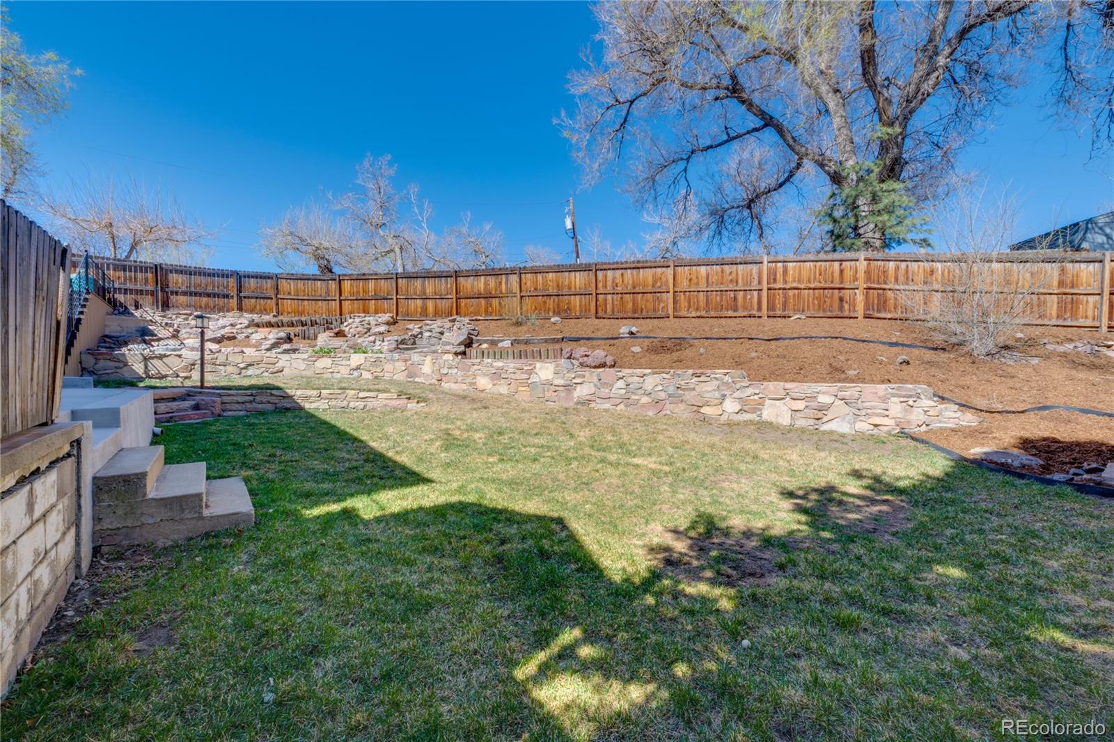 6811 West 48th Avenue Wheat Ridge, CO 80033 - Photo 26 of 33 a view of a yard with wooden fence