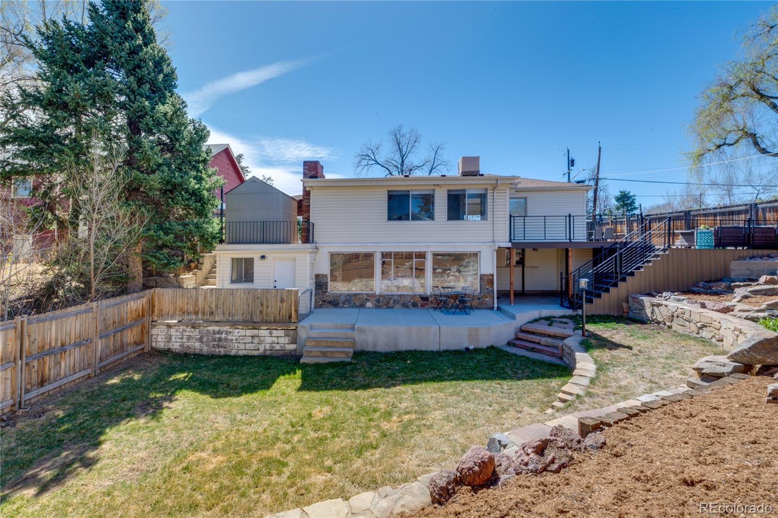 6811 West 48th Avenue Wheat Ridge, CO 80033 - Photo 27 of 33 a front view of a house with a yard