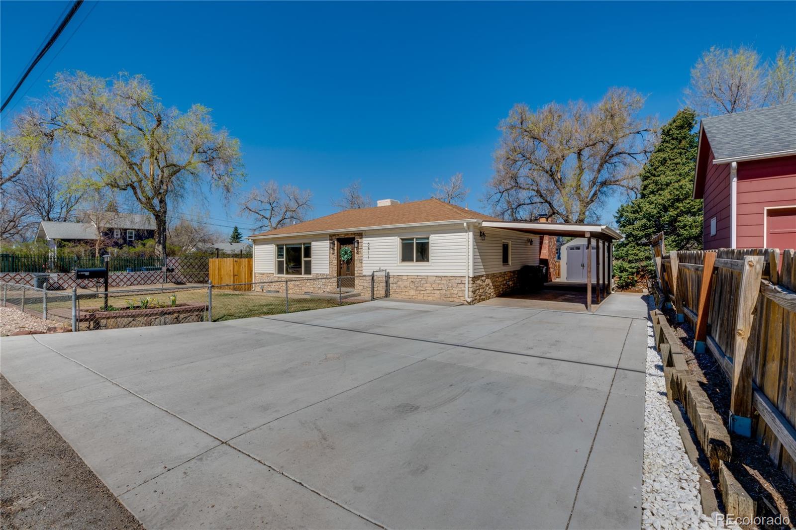 6811 West 48th Avenue Wheat Ridge, CO 80033 - Photo 31 of 33 a front view of a house with garden