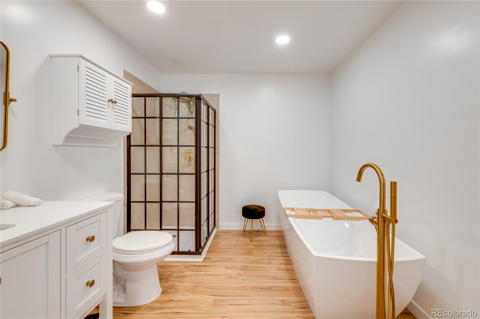 6811 West 48th Avenue Wheat Ridge, CO 80033 - Photo 10 of 33 a bathroom with a toilet sink and mirror