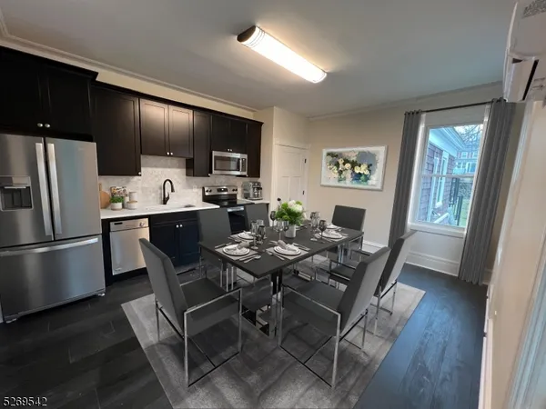 a dining room with furniture a window and wooden floor