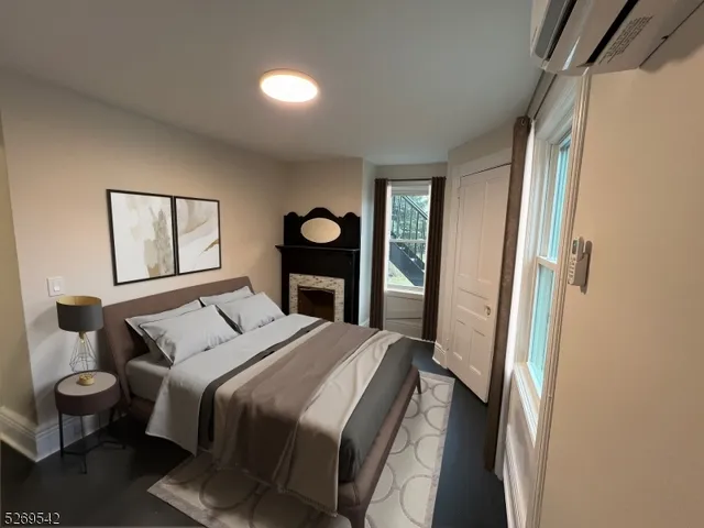 a bedroom with a bed and a large mirror