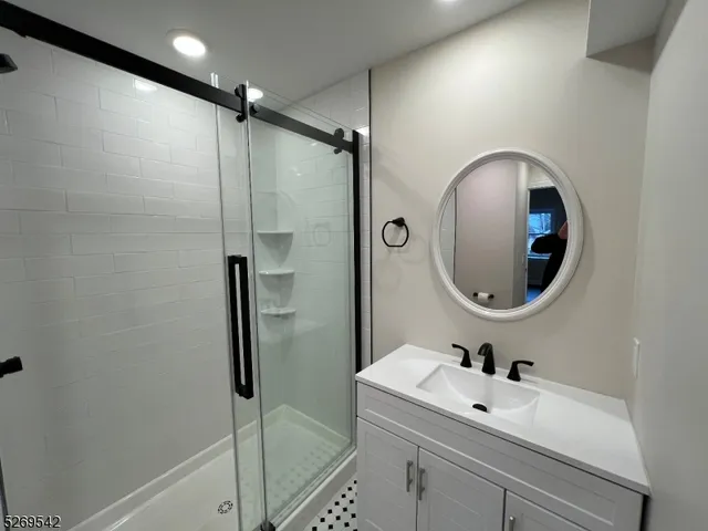 a bathroom with a sink mirror toilet and shower