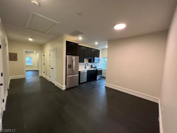 a view of a kitchen with a sink and a refrigerator