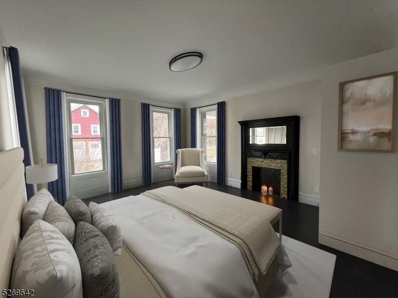 314 Cornelia Street, Unit 4 Boonton, NJ 07005 - Photo 7 of 32 a bedroom with a balcony a bed and a fireplace