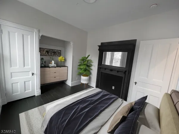 a bedroom with a bed closet and mirror