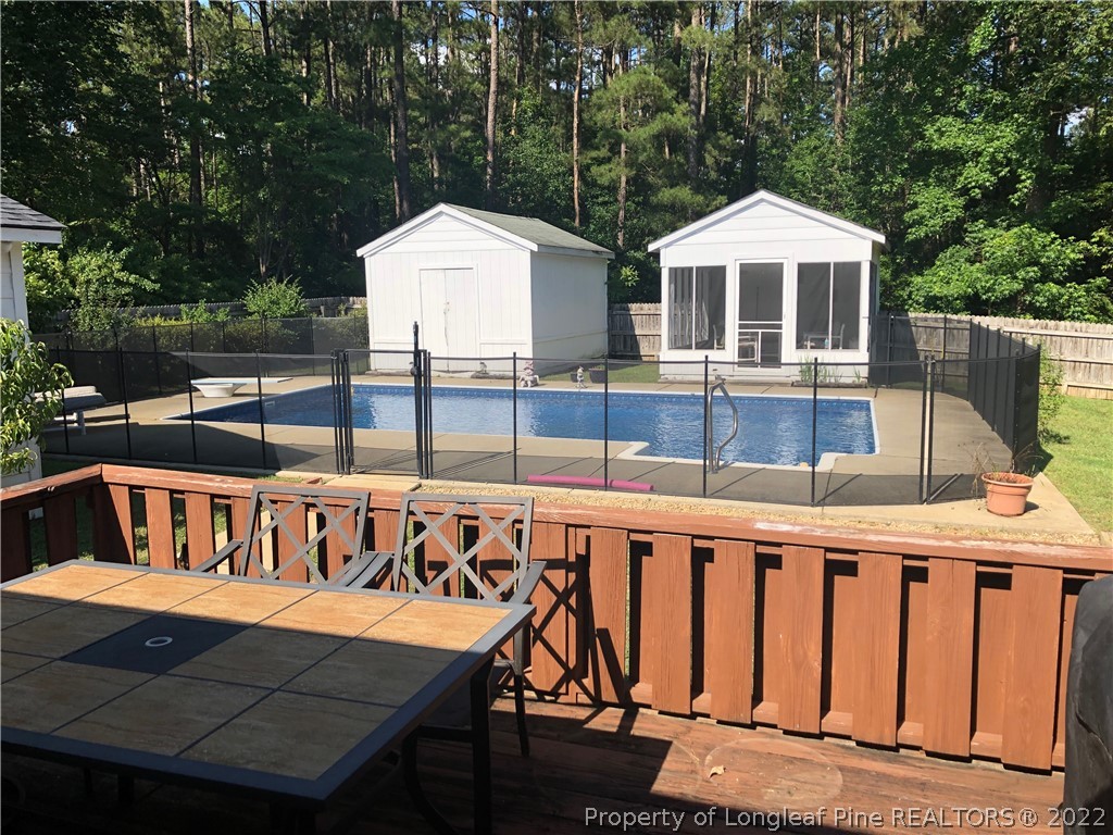 310 Old Farm Road Raeford, NC 28376 - Photo 2 of 29 a roof deck with a table and chairs