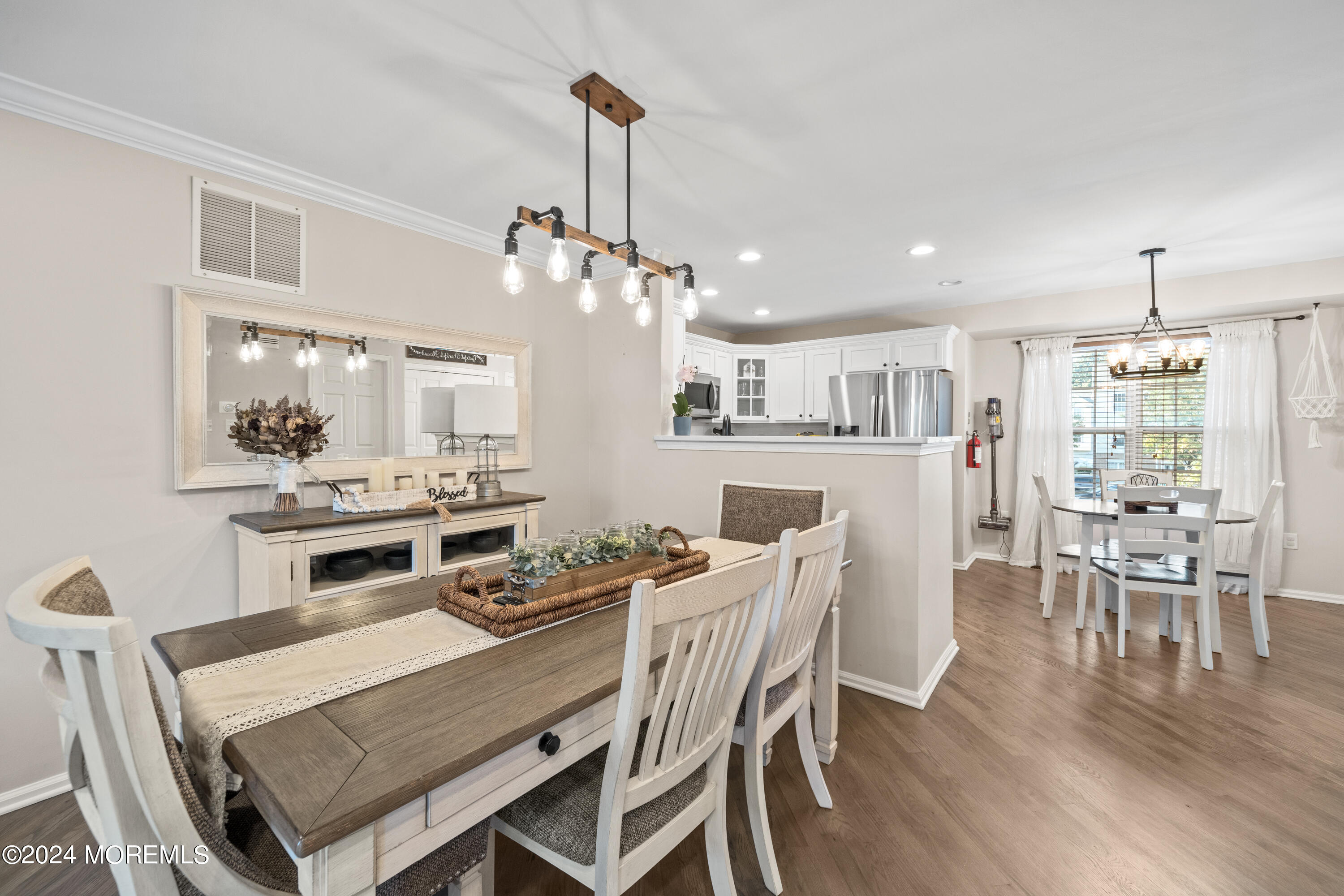 5 Kuczynski Drive, Unit 945 Parlin, NJ 08859 - Photo 15 of 62 a view of a dining room with furniture and wooden floor
