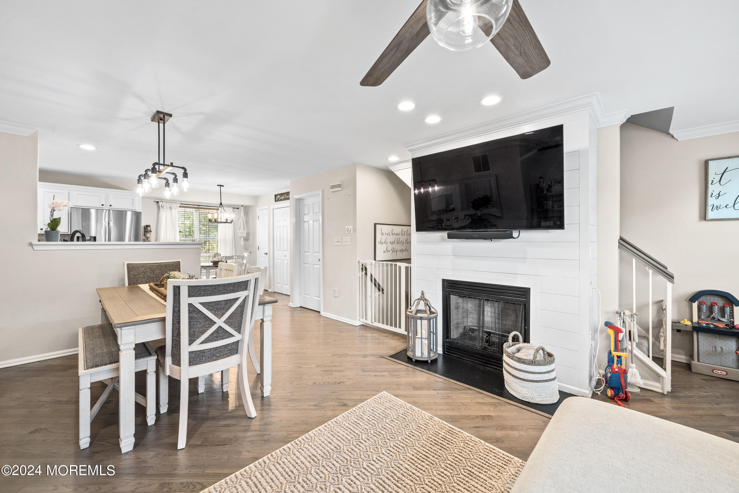 5 Kuczynski Drive, Unit 945 Parlin, NJ 08859 - Photo 17 of 62 a living room with furniture a flat screen tv and kitchen view