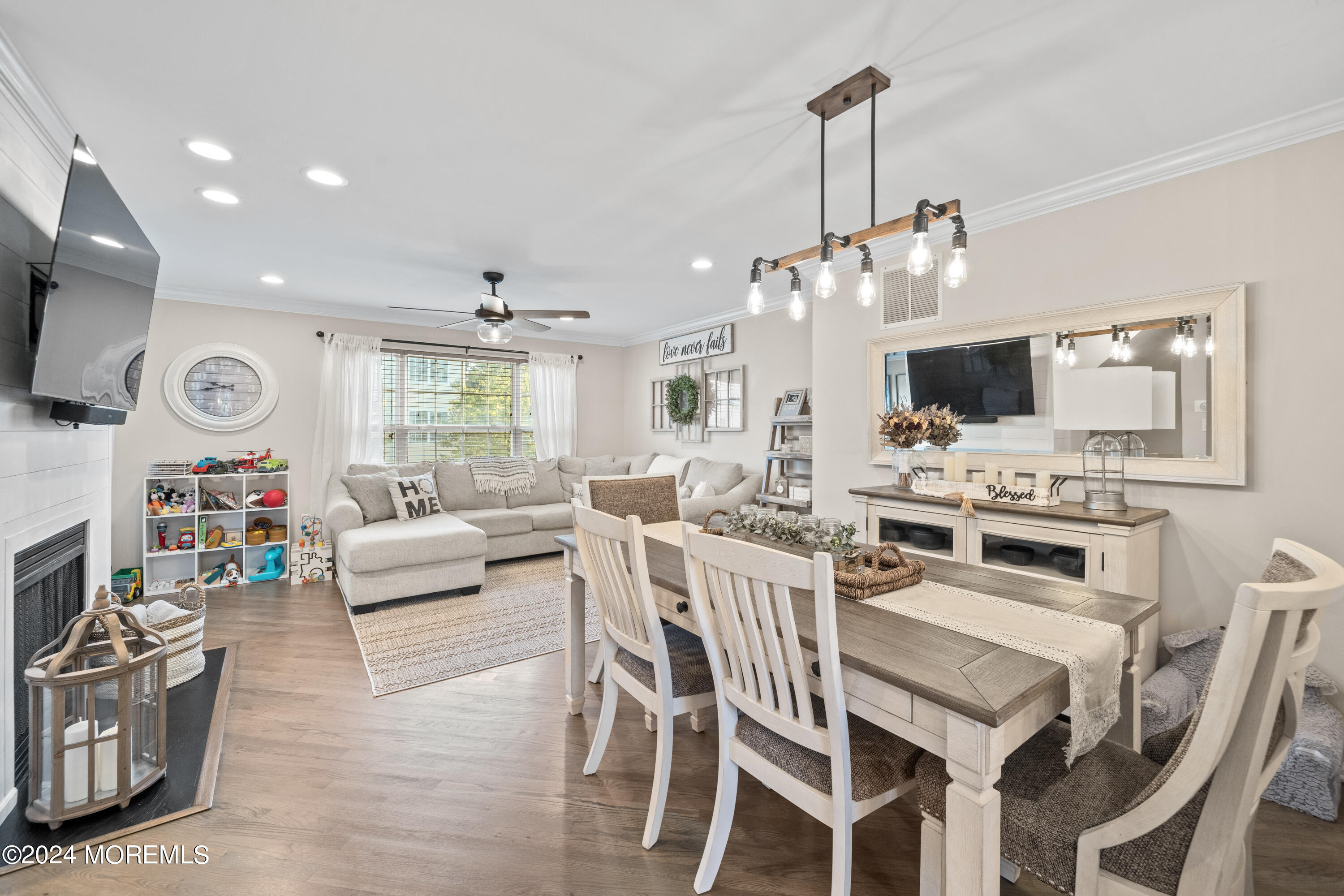 5 Kuczynski Drive, Unit 945 Parlin, NJ 08859 - Photo 18 of 62 a kitchen with stainless steel appliances kitchen island granite countertop a stove a sink a dining table and chairs with wooden floor